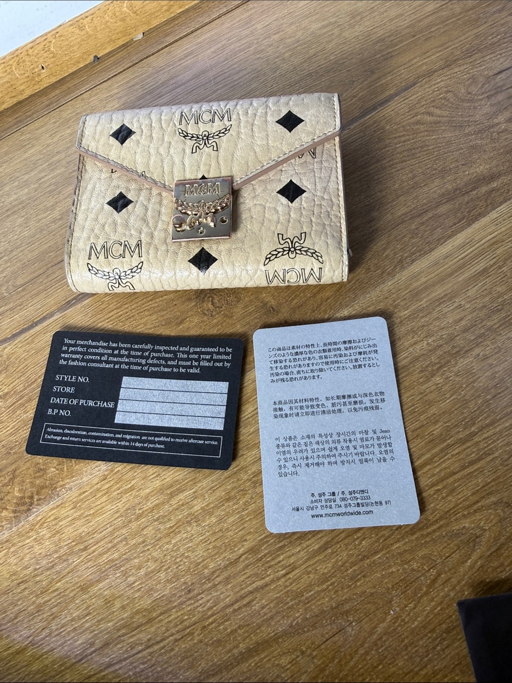 MCM Visetos compact trifold-style wallet with paperwork